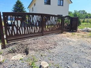 Modernes braunes Gartentor mit organischem Lasercut-Muster – stilvolle Einfahrtlösung für moderne Wohnhäuser.