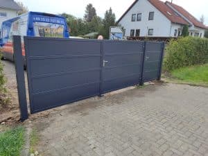 Modernes Gartentor mit integrierter Tür und klaren horizontalen Linien – stilvolle und funktionale Einfahrtlösung.