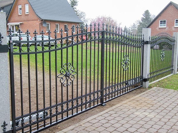 Schmiedeeisernes Tor vor einem Wohnhaus.