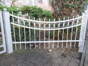 Gusseisernes Tor mit Ornamenten im Garten.