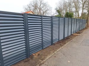 Moderner Metallzaun mit Lamellenfüllung als Sichtschutz, hergestellt von KOMABUD.